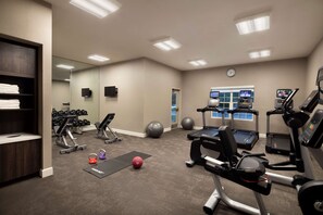 A gym with treadmills, elliptical machines, free weights, and exercise balls. - Sonesta ES Suites Fresno (Fresno)