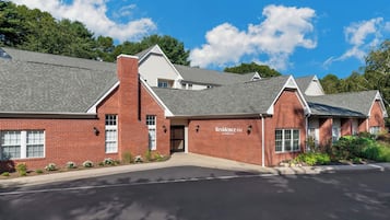 A brick building with a sign reading 'Residence Inn by Marriott' indicating a hotel.