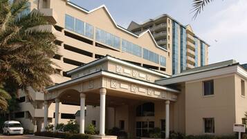 Stunning hotel with a central entrance, flanked by two wings, and a classical portico.