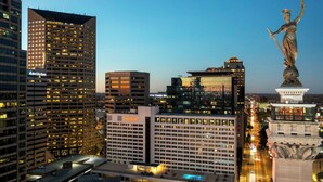 A cityscape with high-rise buildings, including a Sheraton hotel, and a statue on a pedestal. - Sheraton Indianapolis City Centre Hotel (Indianapolis)