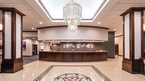 A hotel lobby with a reception desk, a chandelier, and a decorative floor pattern. - Sheraton Indianapolis City Centre Hotel (Indianapolis)