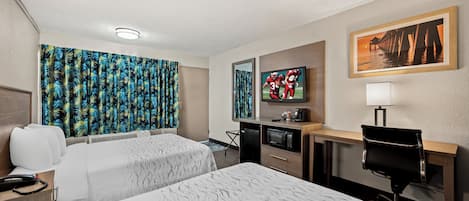 A hotel room with two beds, a desk, a chair, a TV, and a painting on the wall.
