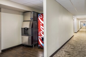 A hallway with a vending machine and a Coca-Cola refrigerator. - Red Roof Inn PLUS+ Boston - Woburn/ Burlington (Woburn)