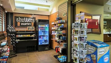A Shutters Pantry with a refrigerated display, a beverage cooler, and a Nestle ice cream display.
