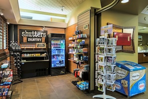 A Shutters Pantry with a refrigerated display, a beverage cooler, and a Nestle ice cream display.