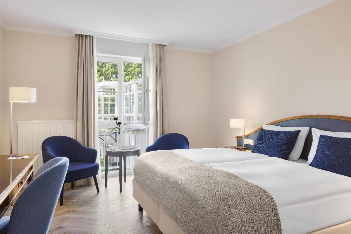Premium bedding, desk, laptop workspace, blackout drapes
