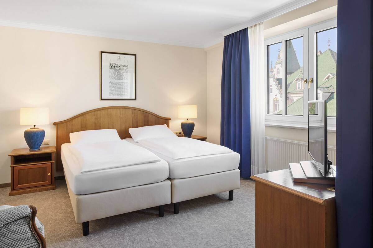 Premium bedding, desk, laptop workspace, blackout drapes