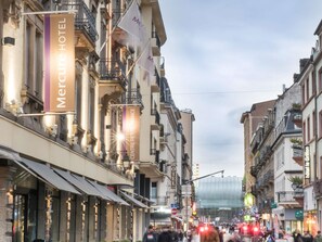 A street view with the Mercure Hotel sign, indicating a hotel presence.