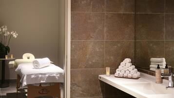 Bathroom features a bathtub, shower, and a large mirror above the sink.