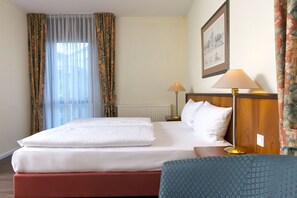 Standard Double Room | Minibar, in-room safe, desk, blackout drapes