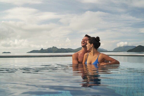 4 outdoor pools, open 7:00 AM to 8:00 PM, pool umbrellas, pool loungers