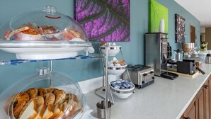 A breakfast buffet with various pastries and bread, a coffee station, and a toaster. - Sleep Inn Fayetteville I-95 (Fayetteville)