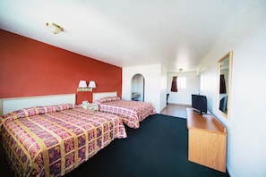 A hotel room with two beds, a desk, a TV, and a mirror. - Superior Suites Phoenix Mesa (Mesa)