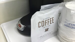 A coffee maker with a label reading "maid" and a bag of coffee labeled "Fresh Coffee Inside." - Signature Inn Merced Yosemite Parkway (Merced)