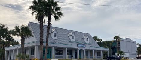 A two-story building with a sign reading "Remington Suites."