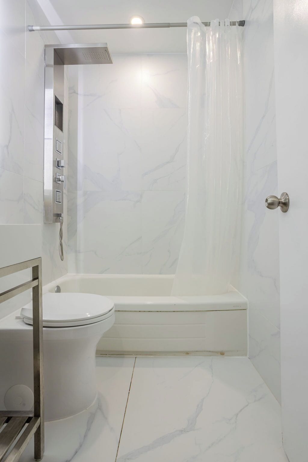 A modern bathroom with a shower, toilet, and a bathtub.