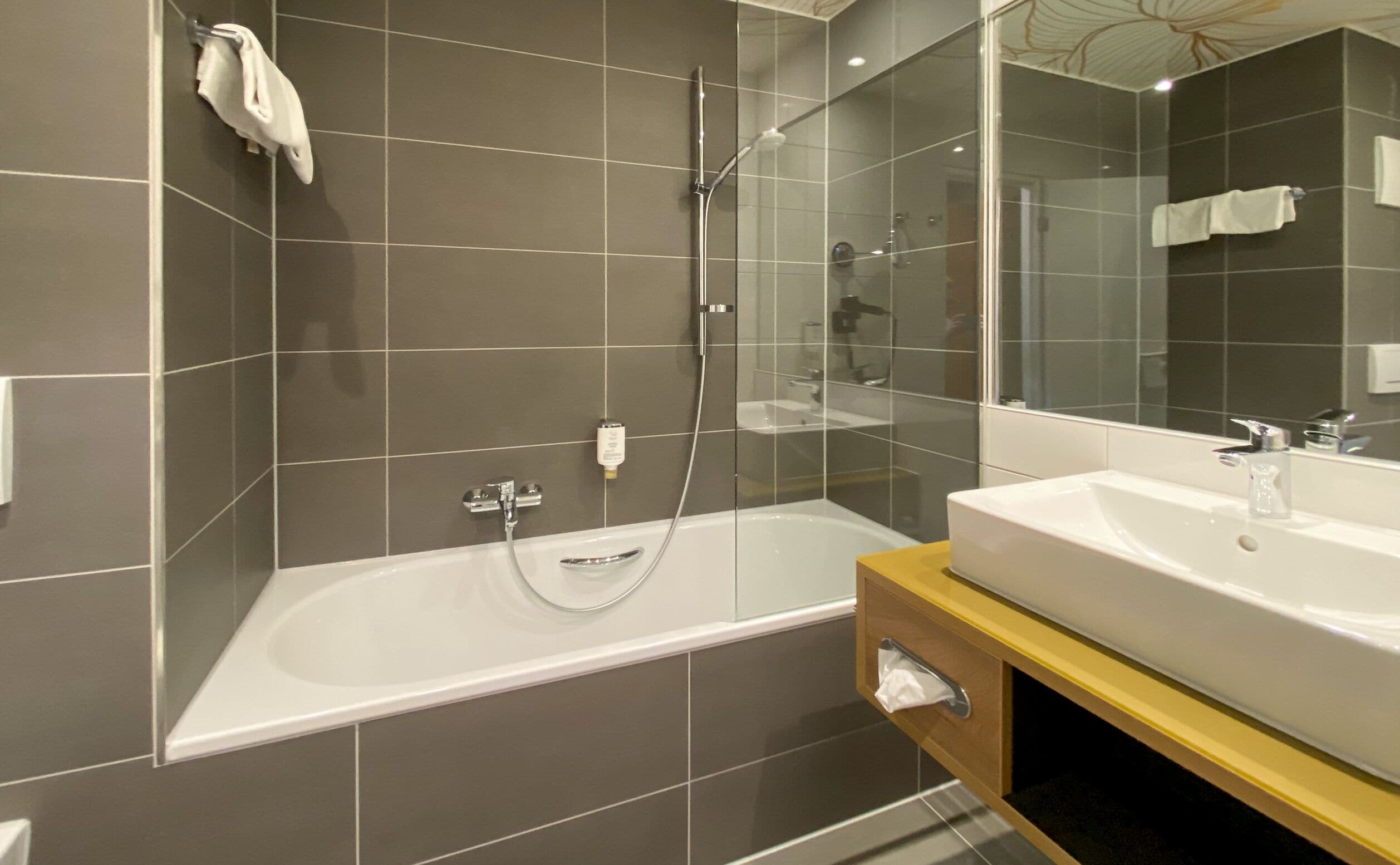 family room with bathtub | bathroom | hair dryer, towels, soap, shampoo