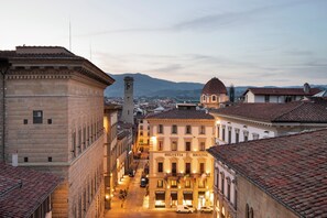 A historic street with traditional architecture, including a prominent building labeled 'Helvetia Bristol' with a dome and bell tower. - Helvetia & Bristol Firenze – Starhotels Collezione (Florence)
