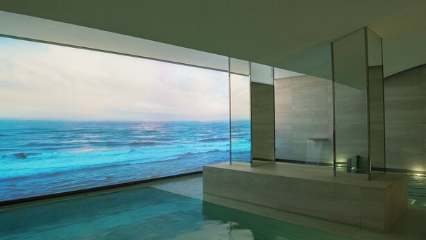 Un baño moderno con un amplio ventanal con vistas al océano.