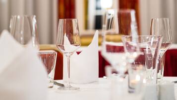 A dining table set with multiple wine glasses and a white napkin.