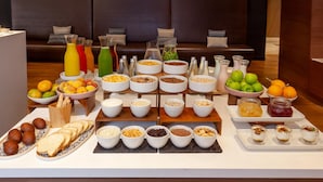 A breakfast buffet with various food items and beverages. - NH Collection Bogotá Andino Royal (Bogotá)
