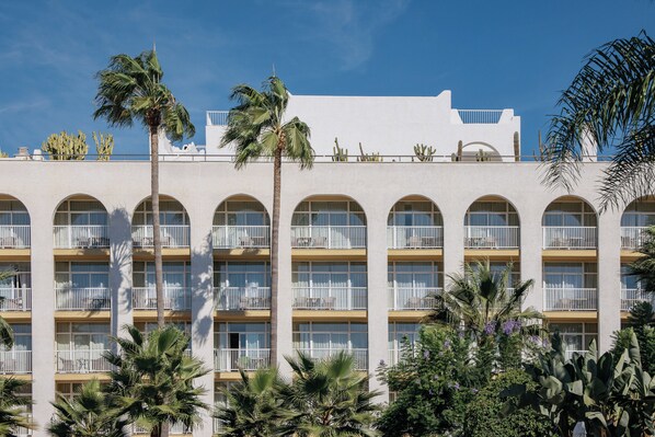 Stunning hotel with modern design, featuring balconies and arched windows.
