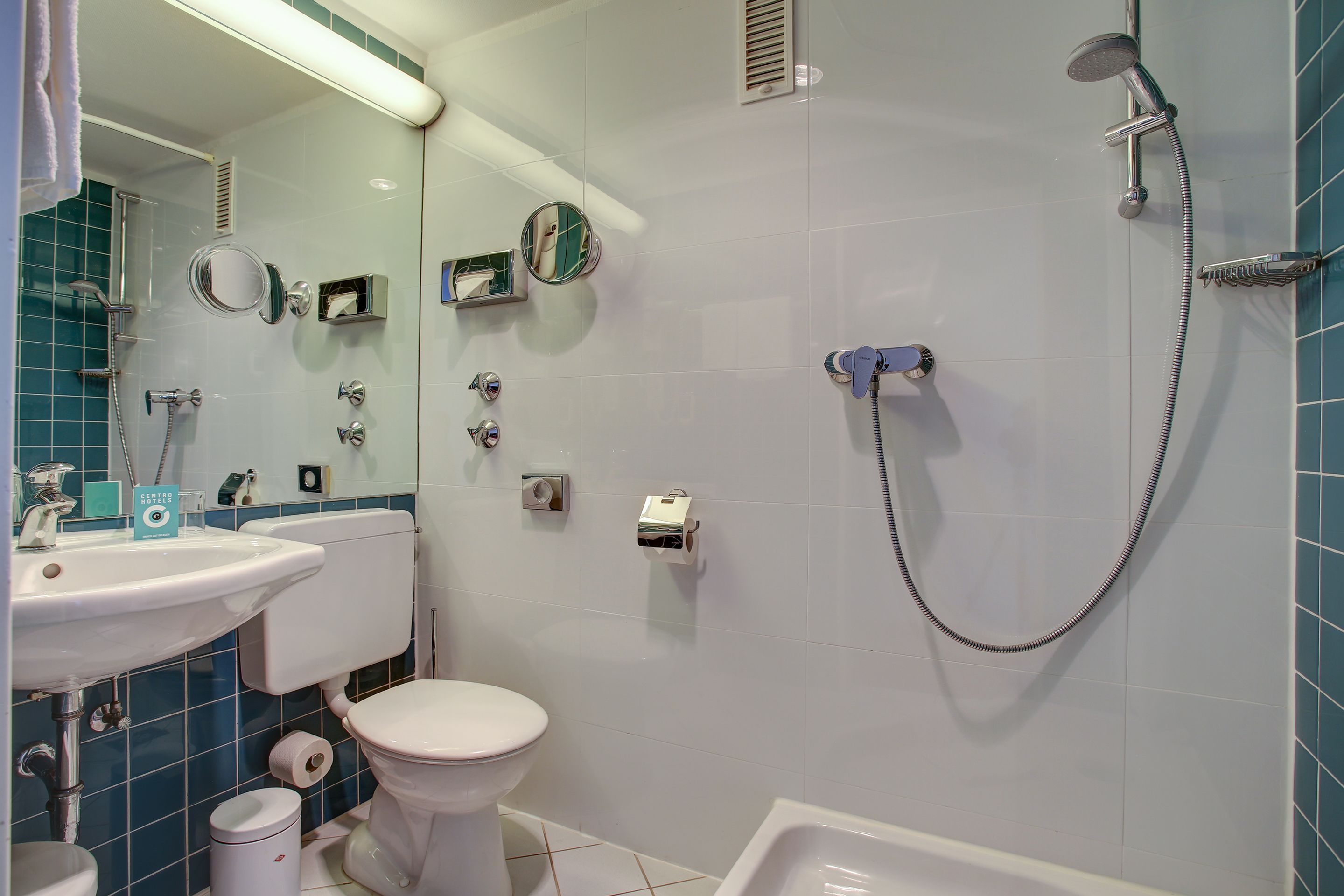 A bathroom with a white sink, toilet, and bathtub.