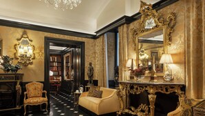 A luxurious lobby with a checkered floor, ornate furniture, and a large mirror with an elaborate frame. - Hotel d'Inghilterra Roma - Starhotels Collezione (Rome)