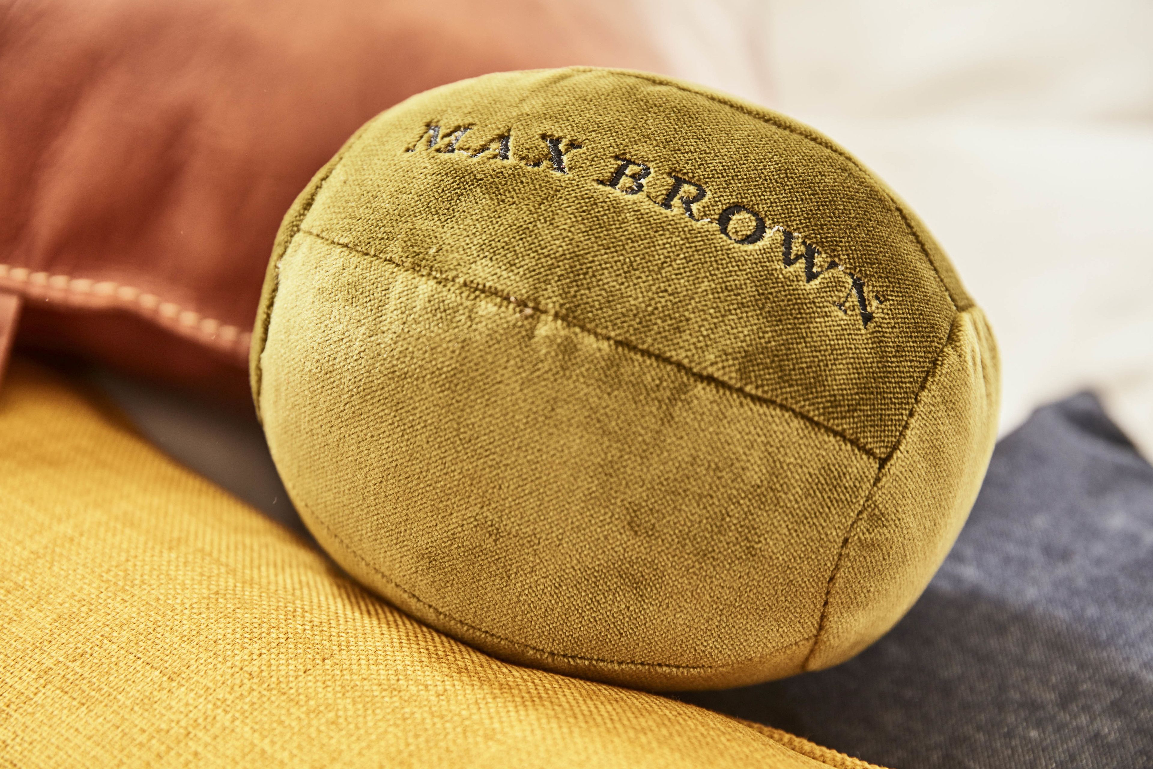 A close-up of a fabric item with the text "MAX BROWN" embroidered on it.