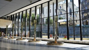 A spacious indoor area with large windows, a tiled floor, and several decorative vases. - Dvorak Spa & Wellness (Karlovy Vary)