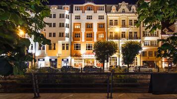 A row of brightly lit hotel buildings with a 'HOTEL' sign above the entrance.