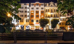 A row of brightly lit hotel buildings with a 'HOTEL' sign above the entrance. - Dvorak Spa & Wellness (Karlovy Vary)
