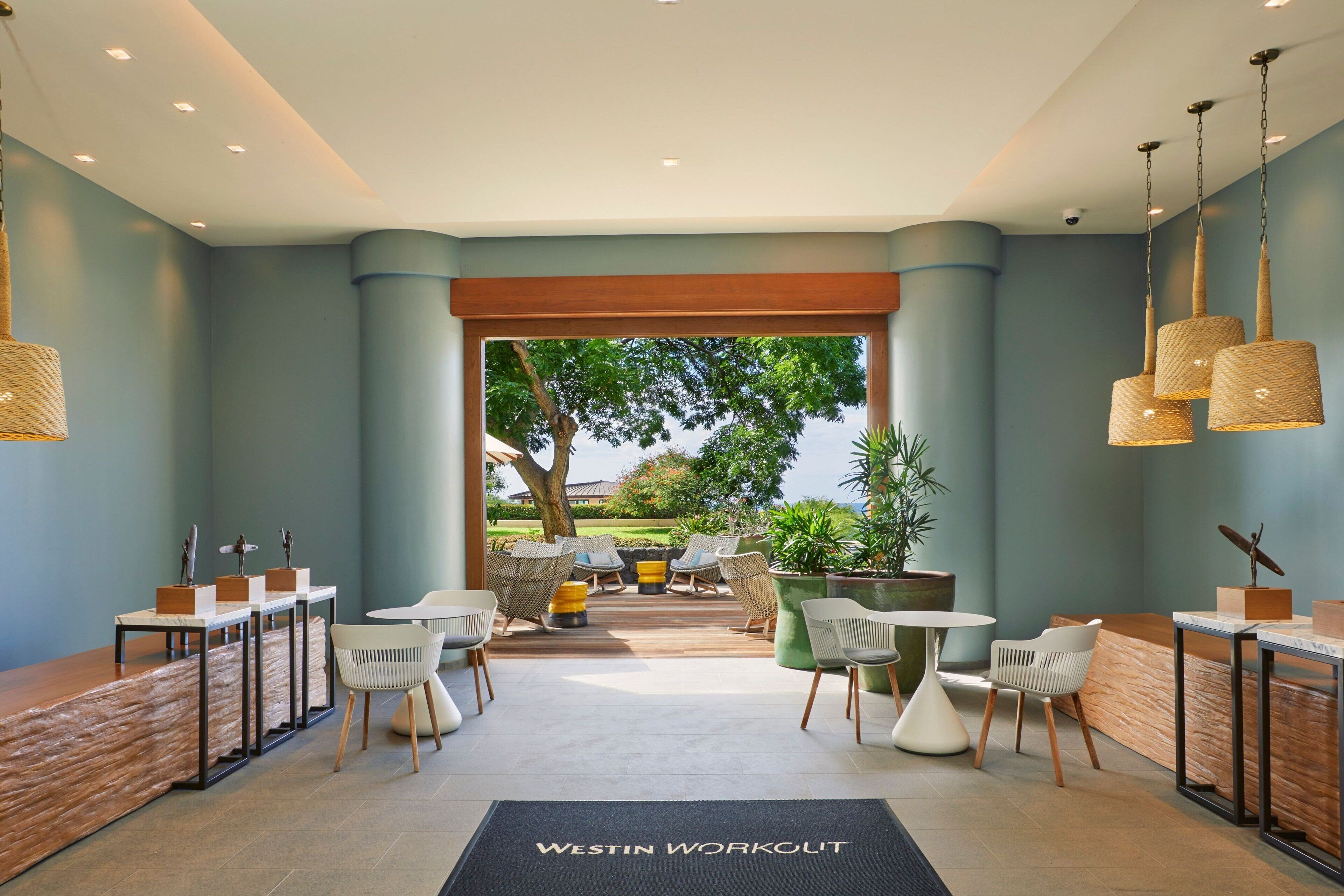 A reception area with a desk, chairs, and a view of the outdoors.