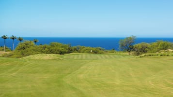 A golf course with a view of the ocean.