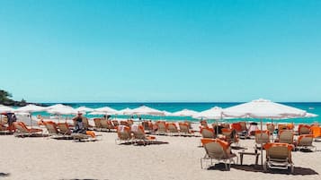 On the beach, sun loungers, beach umbrellas, beach towels