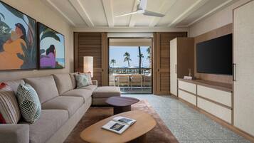 A modern living room with a sofa, coffee table, and artwork on the wall.
