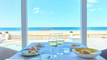 Enjoy a meal with a view of the ocean from this outdoor dining area.