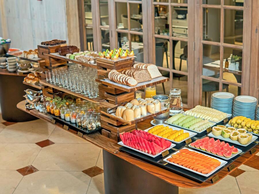 A buffet with various food items and beverages.