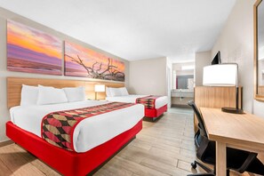 A hotel room with a large bed, a desk, and a chair. There are two paintings on the wall and a mirror. - Days Inn by Wyndham Hoover Birmingham (Birmingham)
