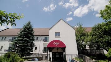 A building with a red awning and a sign that reads "August Moon Spa."