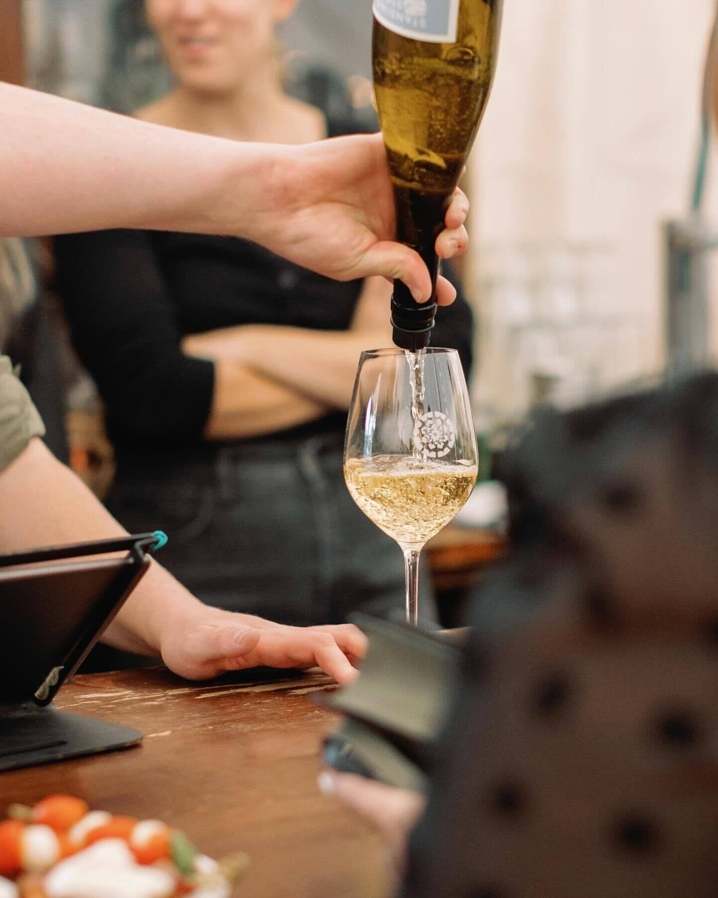 A person pouring a drink into a glass.