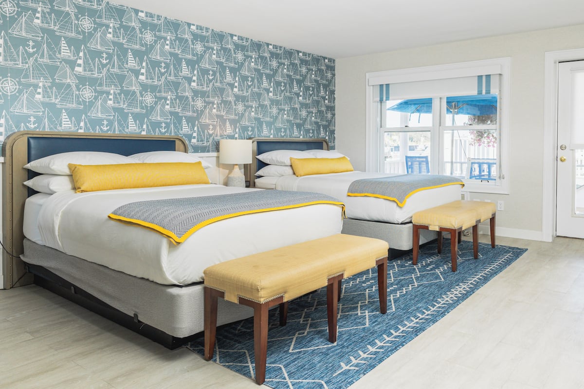 A double bed with a headboard, two bedside tables, and a bench.