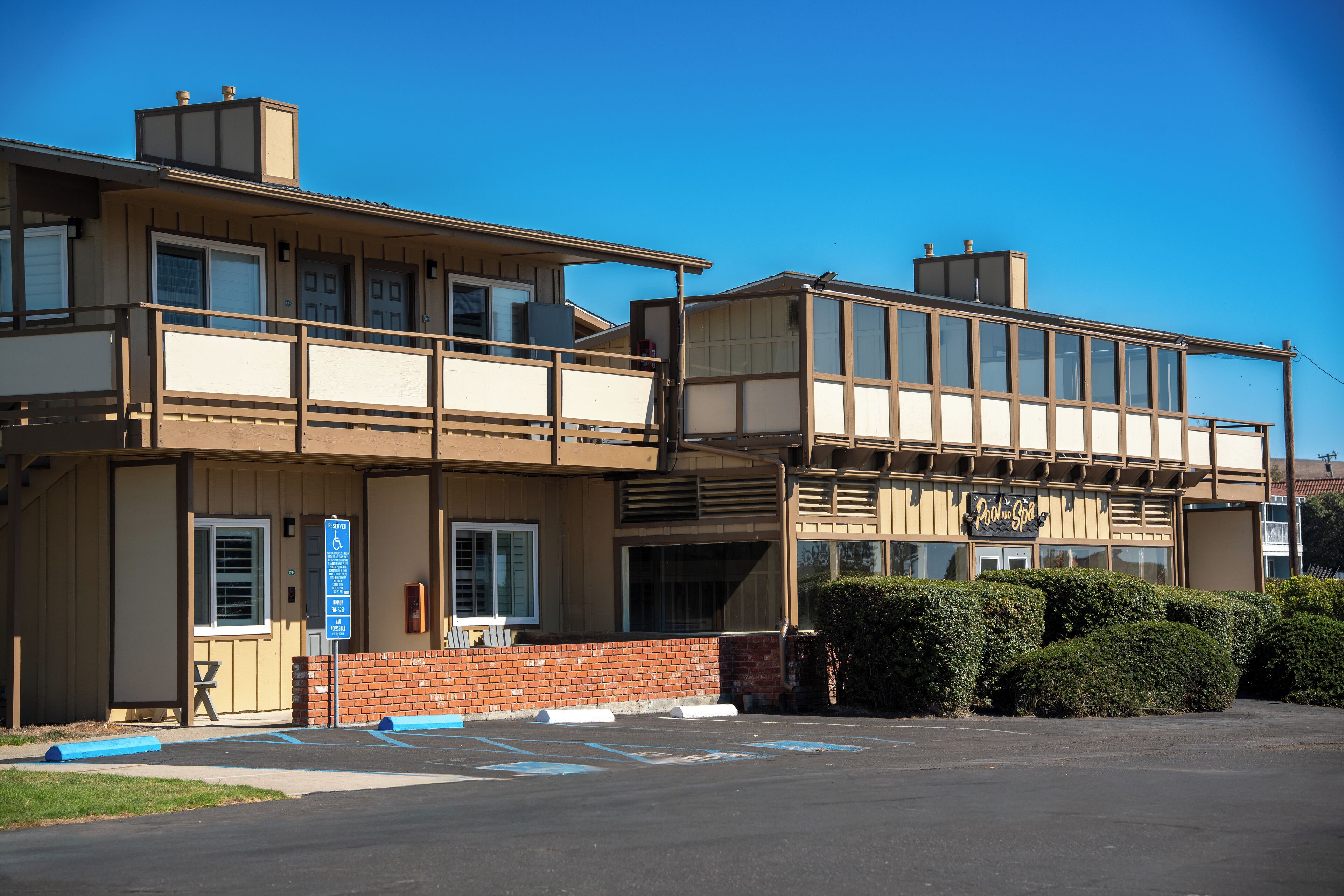 A two-story building with a flat roof and a sign that reads "Cool Spa."