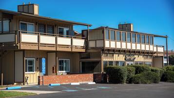A two-story building with a flat roof and a sign that reads "Cool Spa."