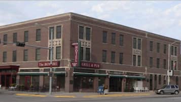 A two-story building with a brick facade, featuring a ground-floor restaurant named "The Bonfire Grill & Pub" and a second-floor establishment called "Hotel El."