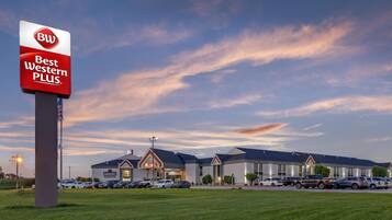 A Best Western PLUS hotel with a parking lot and a clear sky.