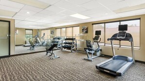 A gym with cardio machines, weight stations, and mirrors. - Quality Inn (Newport News)
