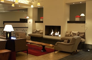 Relax in comfort with sofas, armchairs, and a central fireplace.