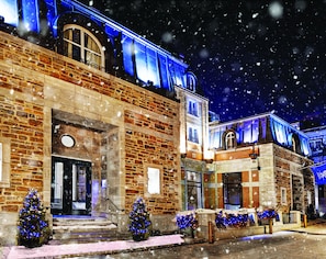 Traditional architecture welcomes you to a festive atmosphere with a charming entrance and seasonal decor.