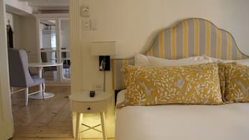A bedroom with a bed, bedside table, and a chair.